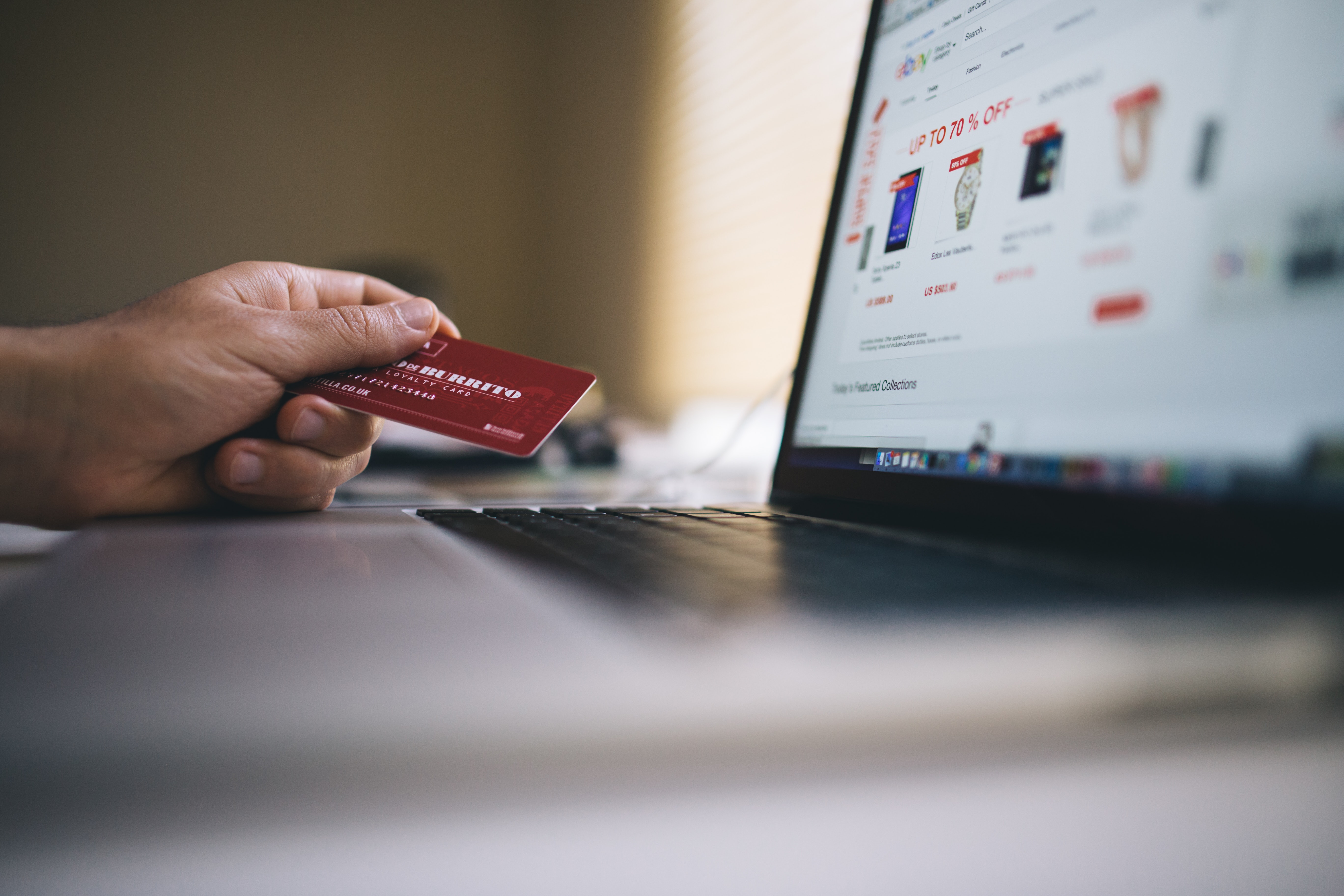 Working Macbook computer keyboard credit card online shopping